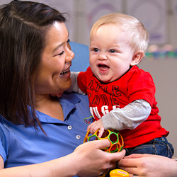 teacher holding infant