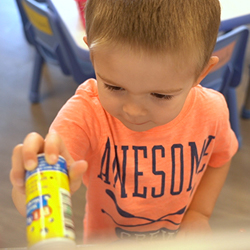 Smiling child in an orange shirt